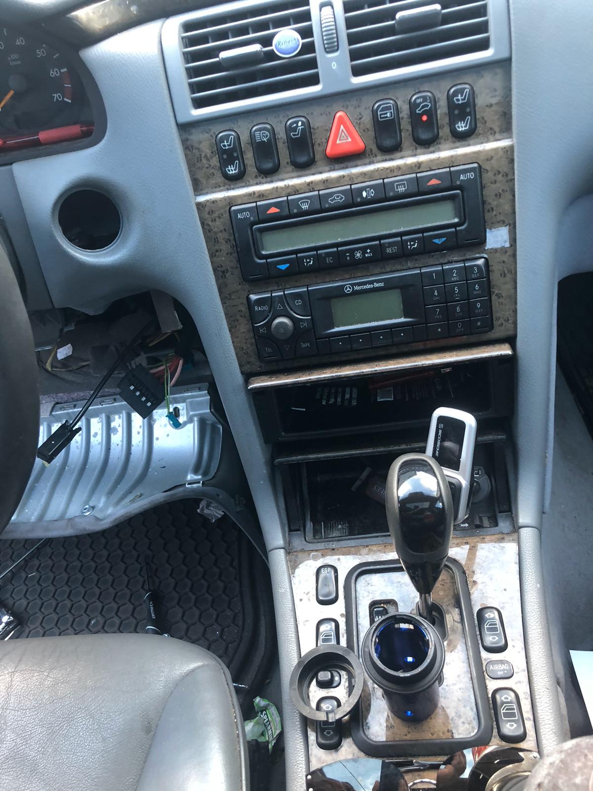 A locksmith technician programming a new car key fob with a diagnostic tool.