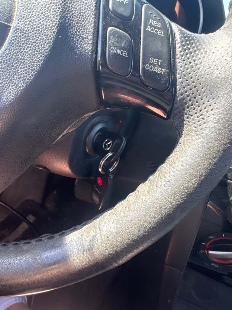 A locksmith technician programming a new car key fob with a diagnostic tool.