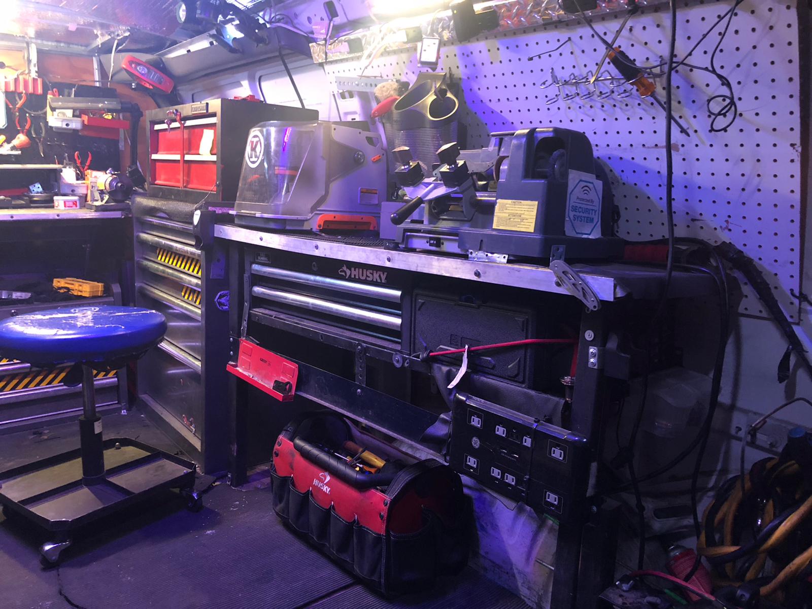 A close-up of a precision laser key cutting machine creating a new car key.