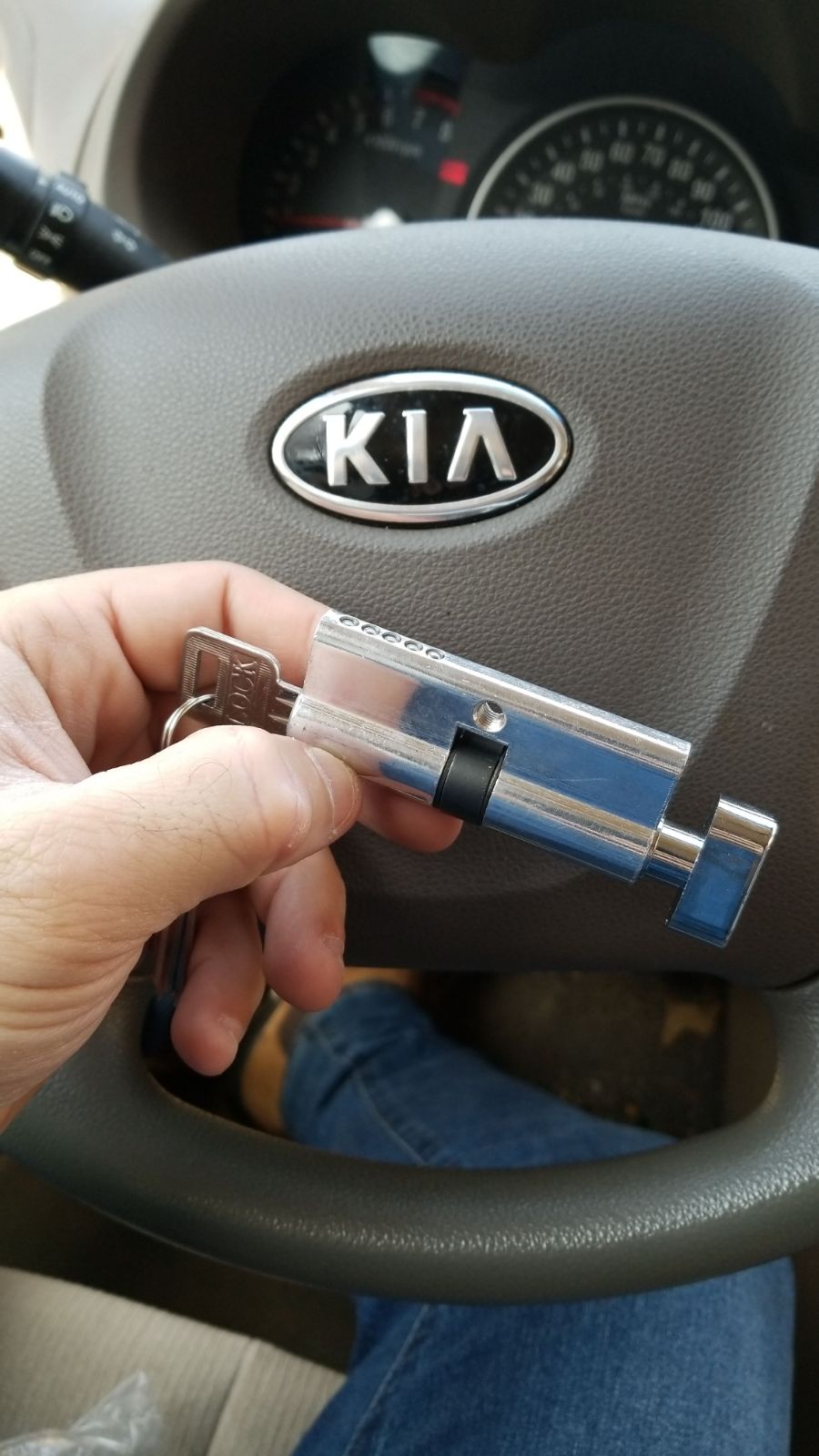 A close-up of a precision laser key cutting machine creating a new car key.