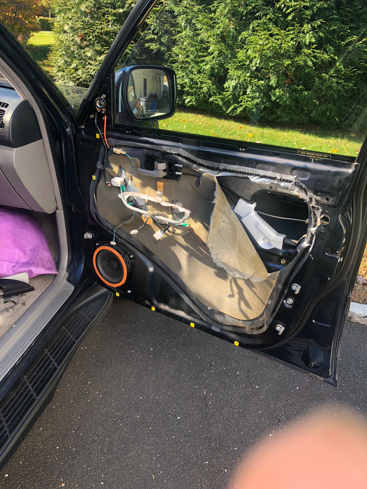 A locksmith technician programming a new car key fob with a diagnostic tool.