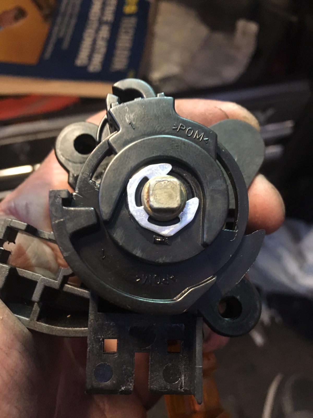 A close-up of a precision laser key cutting machine creating a new car key.